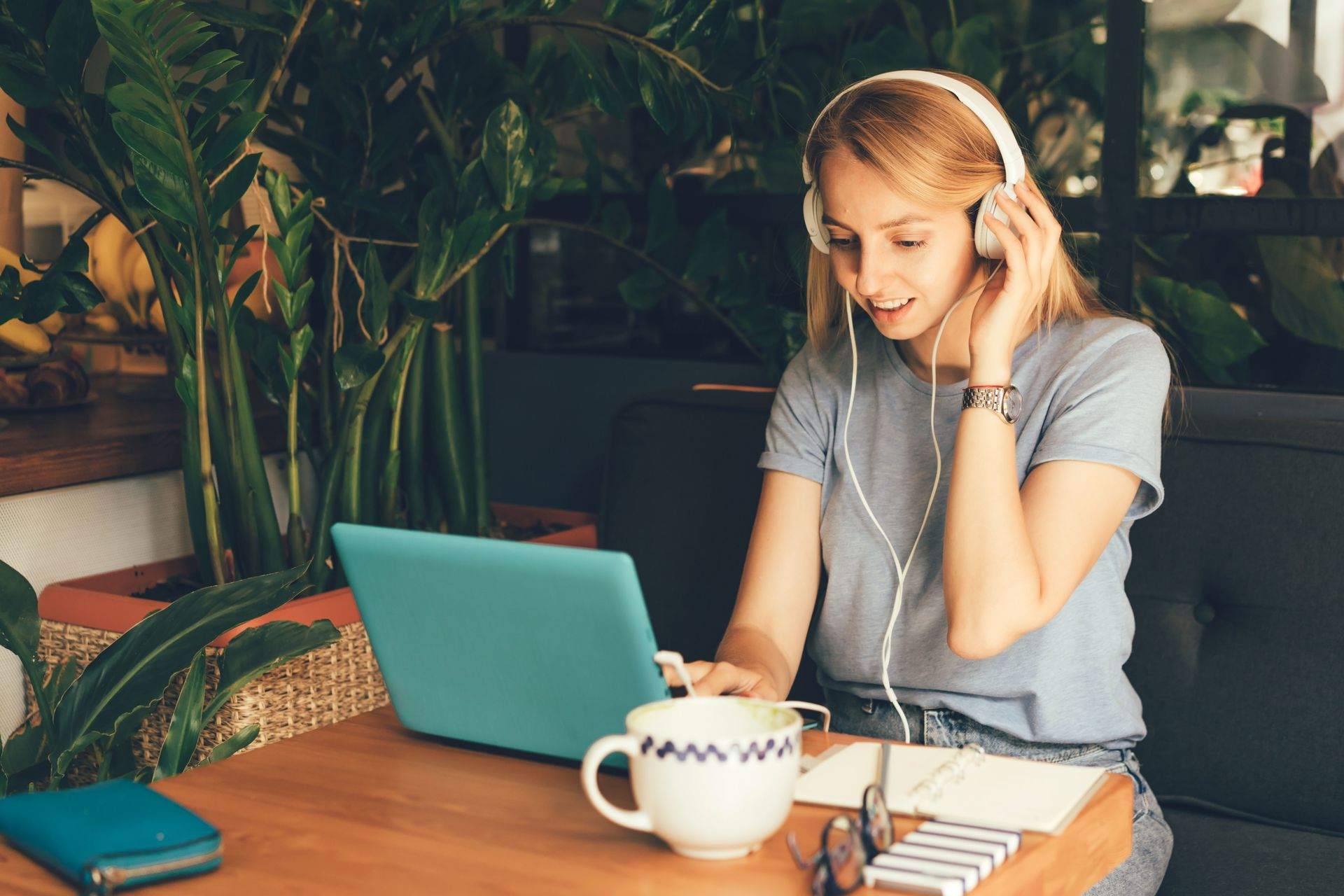 girl-in-headphones-with-laptop-in-cafe-EVE93BR.jpg